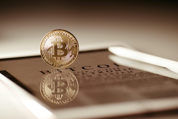 Person holding a phone with a crypto wallet balance
